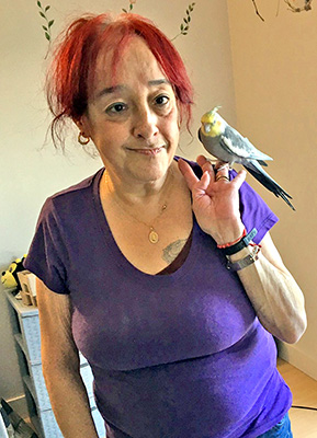 Nora Katz with one of her support birds enjoys living on her own