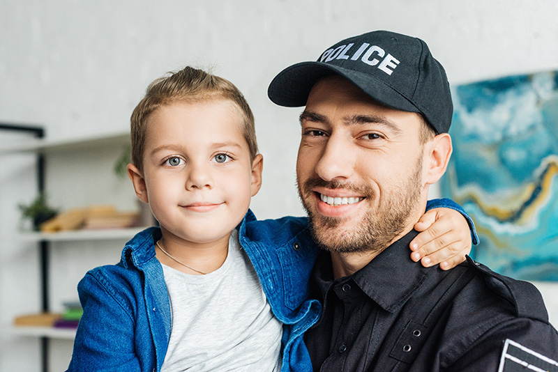 Police officer holding young boy