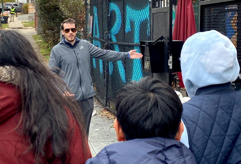 Alex DeCarlo, a Direct Support Professional with AHRC New York City, leads a group from the organization's Staten Island Day Habilitation Without Walls program in the community.