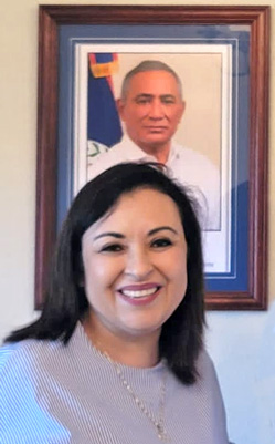 H.E. Rosanna Briceño in front of a photo of her husband, Prime Minister John Briceño