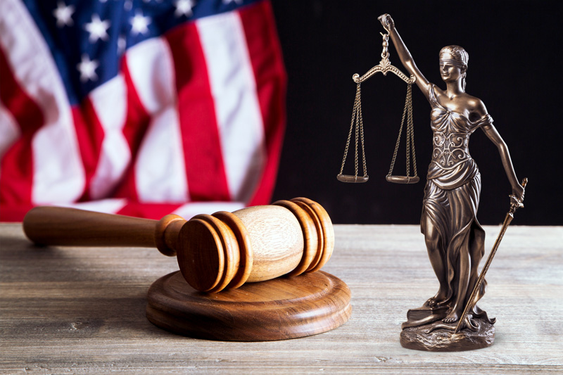 Justice concept with an American flag, gavel and block, and Lady Justice