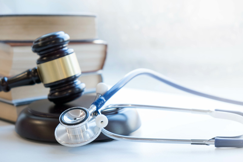 Gavel and stethoscope representing the legal challenges in healthcare
