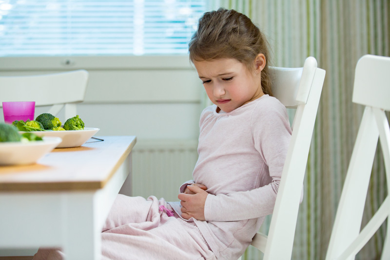 Young girl with an upset stomach; eating and gastrointestinal issues