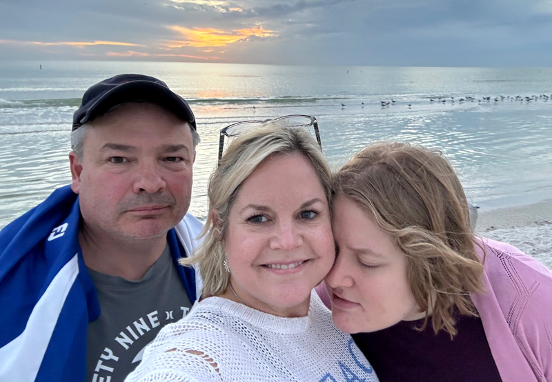 The family enjoying a sunset on the beach.