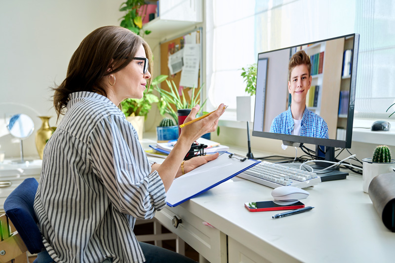 Mature woman talking online with teenage male using video call