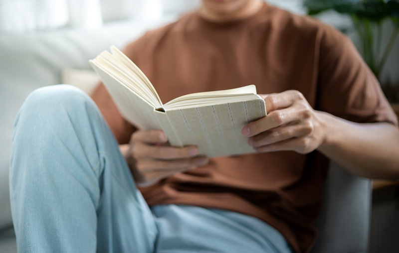 Young man reading a book