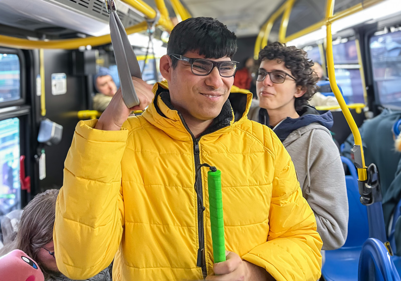 A young man practices accessing public transportation to travel