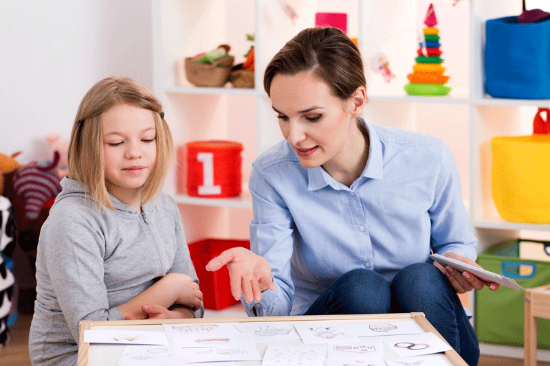 Girl during play therapy session to learn multimodal communication