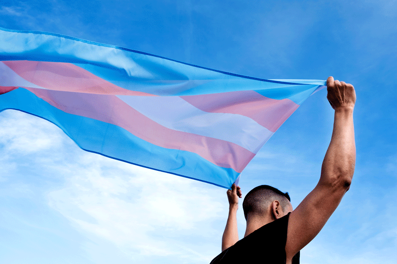 young person with a transgender pride flag