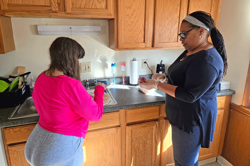 Living Resources Residential Manager Michelle Bynoe in a kitchen with a person she supports