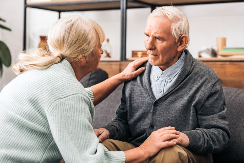 retired couple looking at each other at home