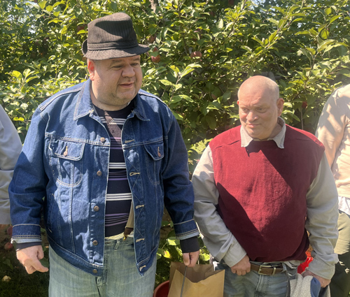 Community elders on the autism spectrum take a peaceful walk through the park, embracing the calm of a familiar outdoor routine.