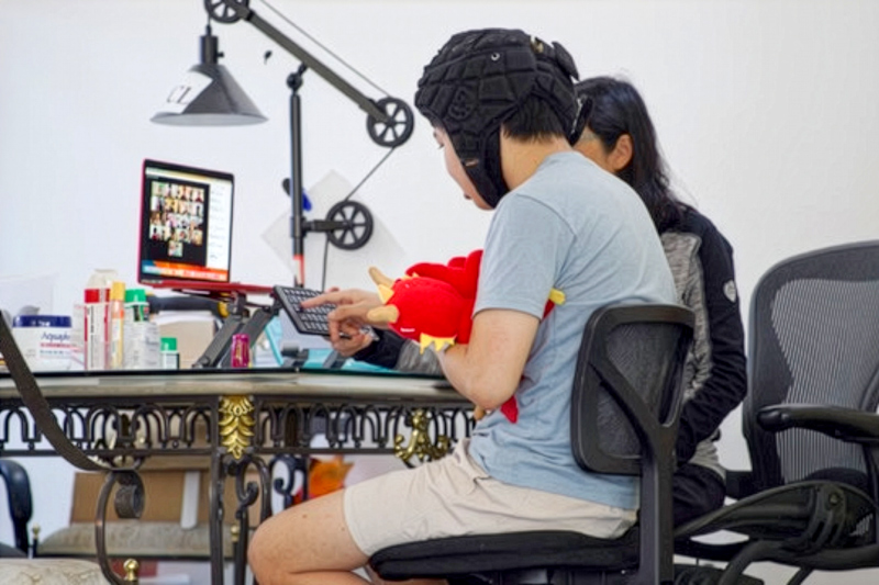 JT, a minimal speaker, typing with his mom, Carol, as his CP. Here he is attending a weekly online social club with his spelling peers.